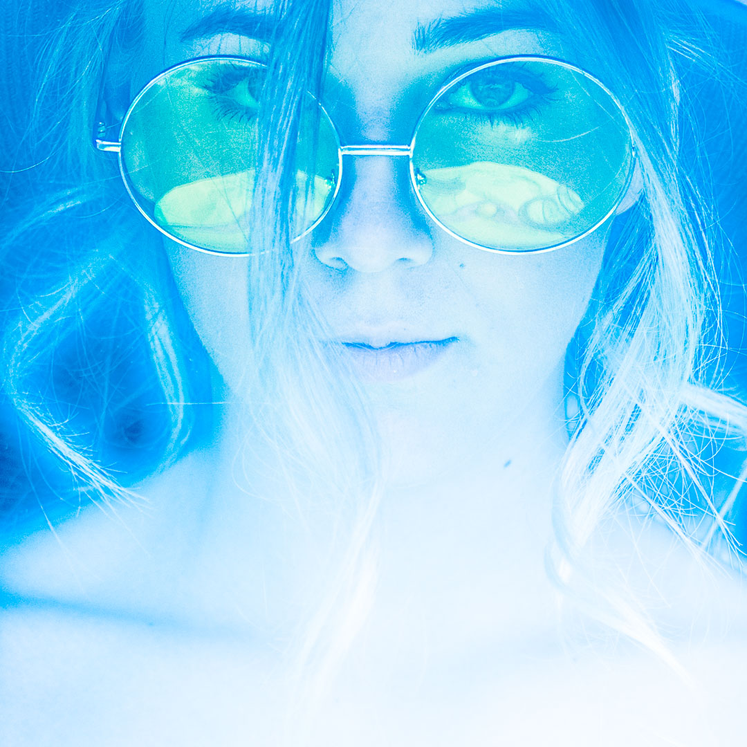A woman wearing blue sunglasses.