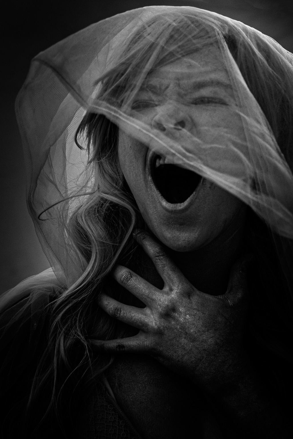 A black and white photo of a woman screaming.