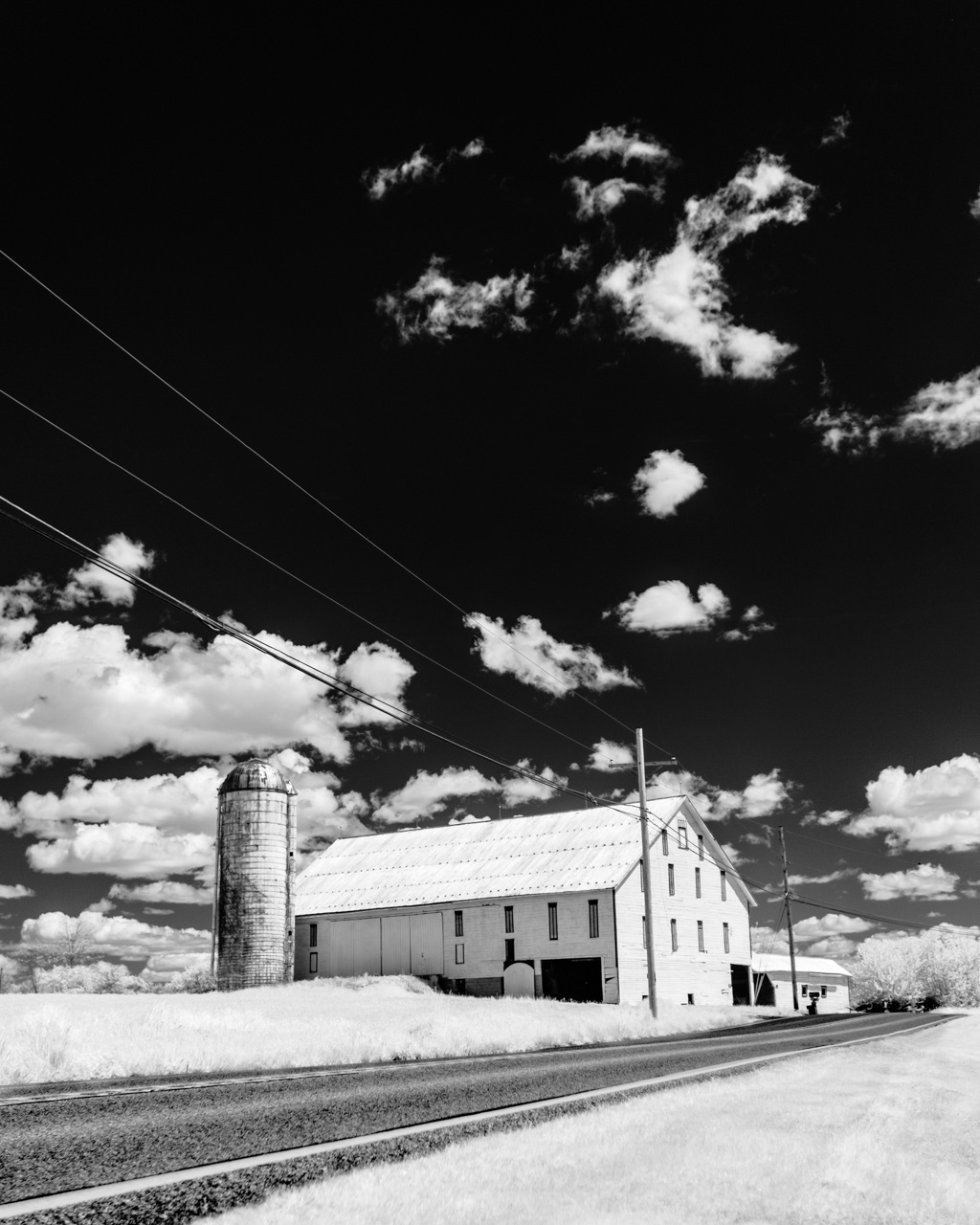 An infrared image of a farm with a silo.