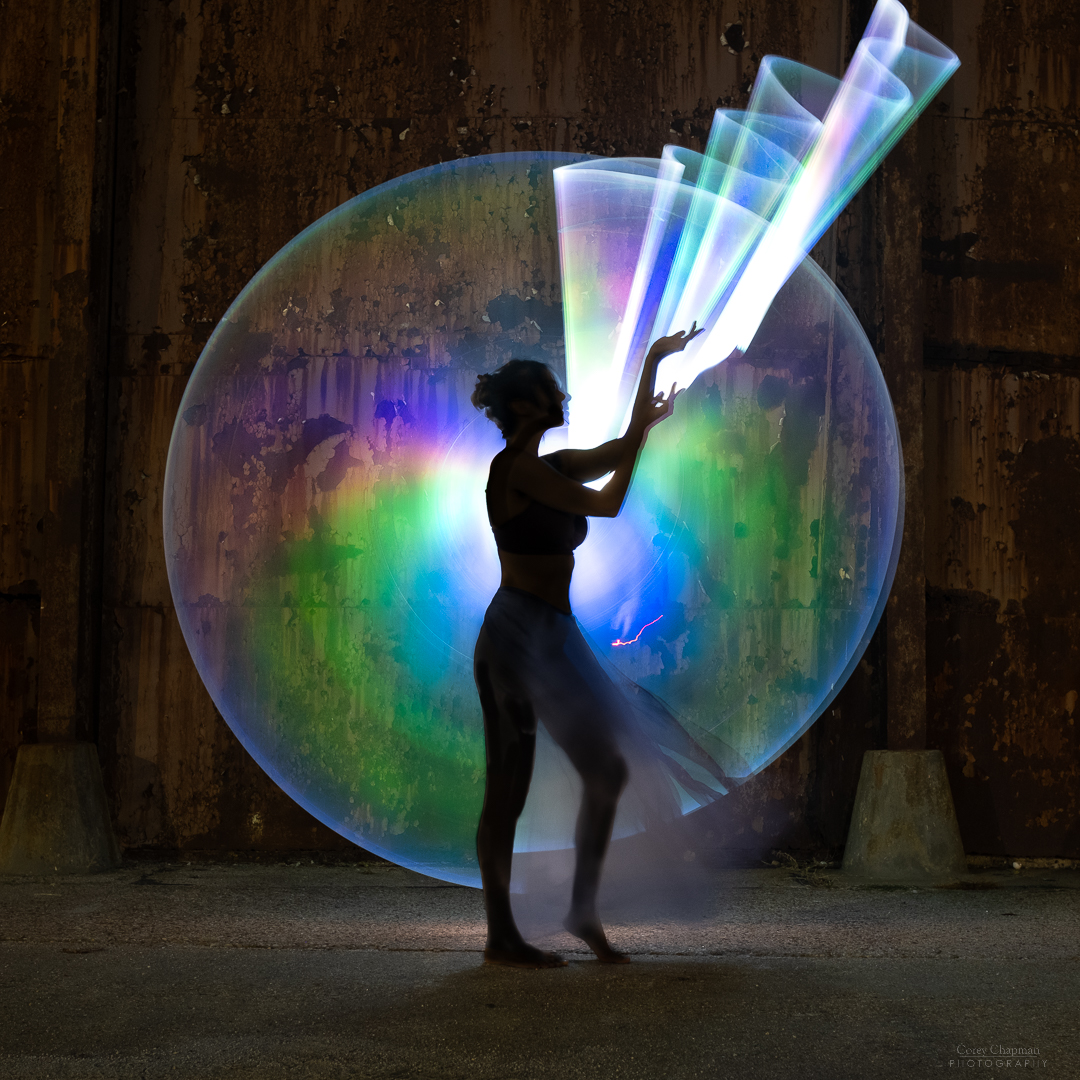 A woman posing with an enormous bubble.